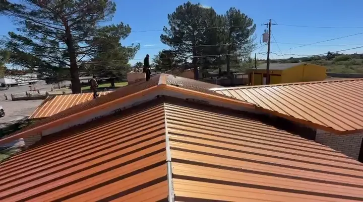 Freshly installed copper-tone metal roof