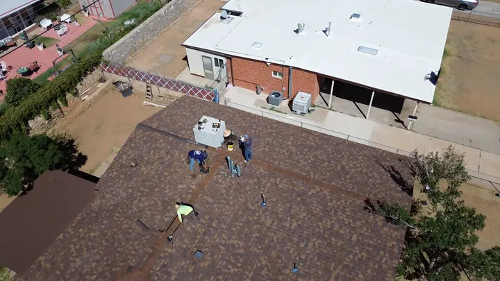 HGC crew working on a shingle roof
