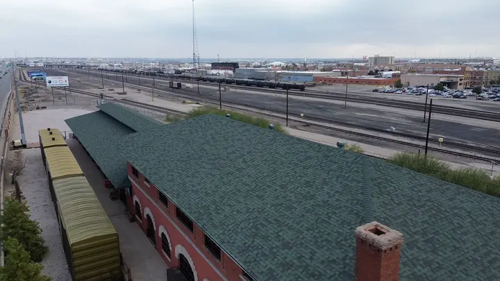 Historic brick building with a green shingle roof near downtown El Paso