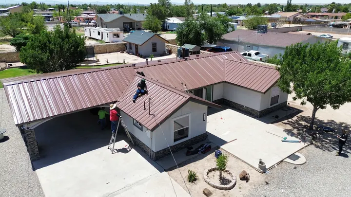HGC crew installing a standing-seam metal roof on an El Paso home