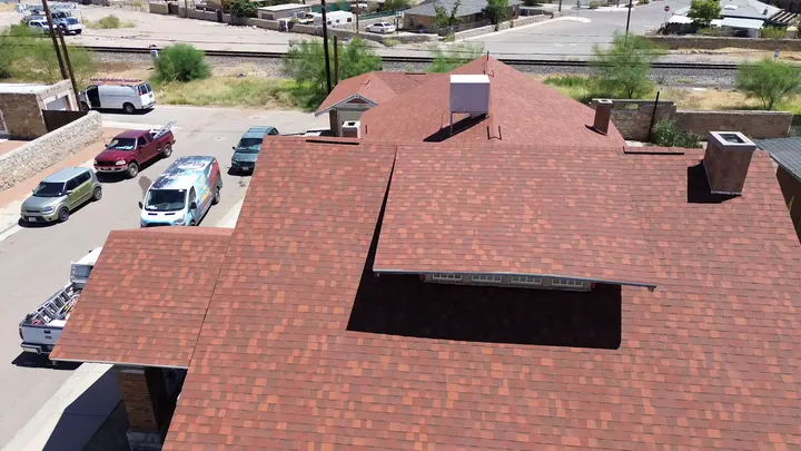Red architectural shingle roof with chimney