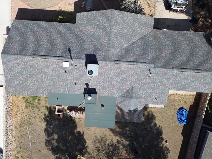 Top-down drone view of a completed shingle roof